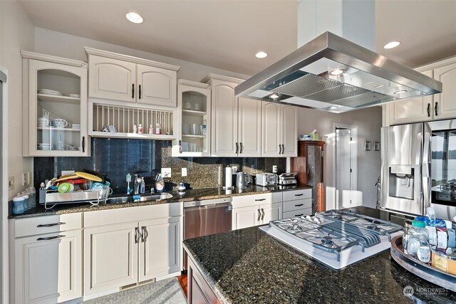 1558 Fairview St, Bellingham, WA 98229 - kitchen with island exhaust hood, stovetop with downdraft, decorative backsplash, glass insert cabinets, and stainless steel fridge