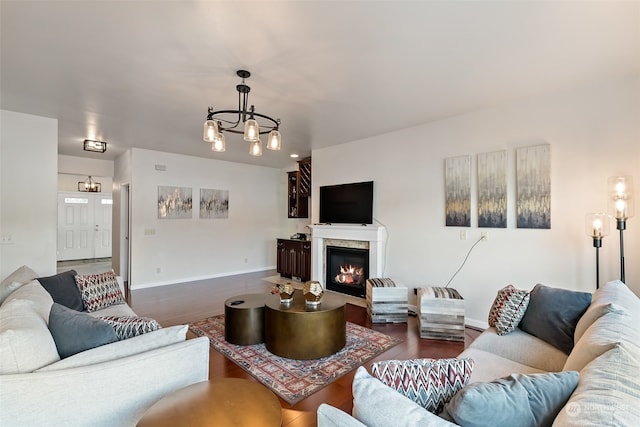 living room with dark hardwood / wood-style floors and a chandelier