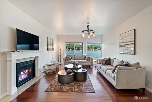 1558 Fairview St, Bellingham, WA 98229 - living area featuring a chandelier, wood finished floors, a glass covered fireplace, and baseboards