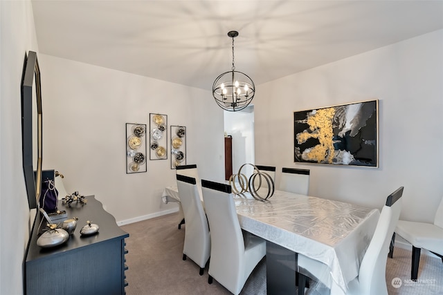 dining space featuring carpet flooring and a chandelier