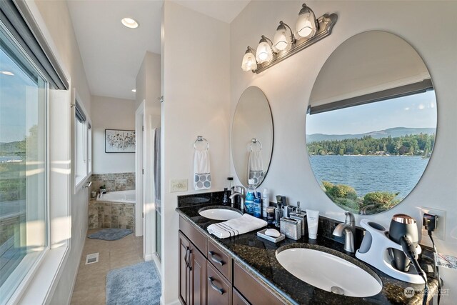 1558 Fairview St, Bellingham, WA 98229 - full bathroom with healthy amount of natural light, a garden tub, double vanity, tile patterned flooring, and recessed lighting