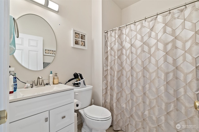 bathroom with vanity, walk in shower, and toilet