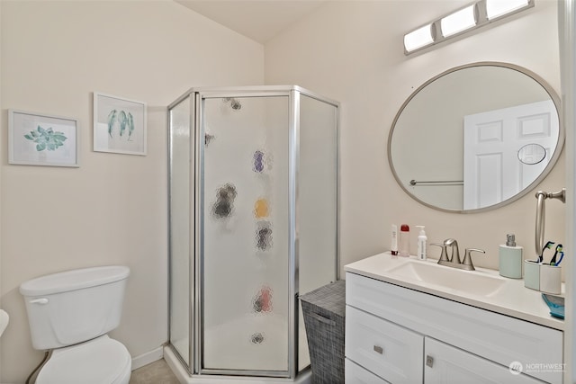 bathroom featuring a shower with door, vanity, and toilet