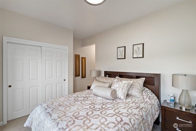 bedroom with a closet and light colored carpet