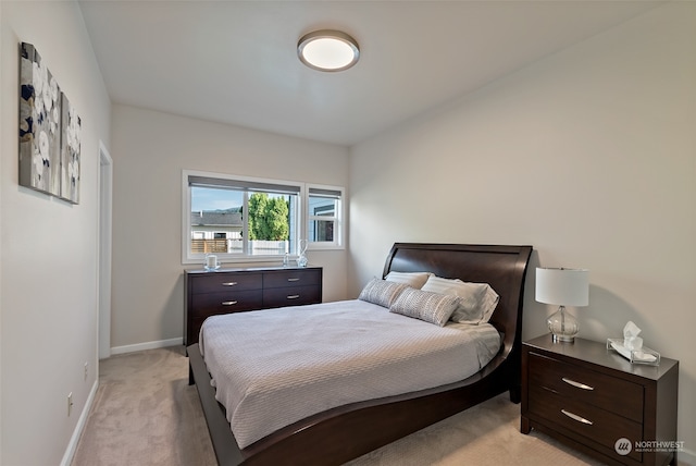 bedroom featuring light carpet