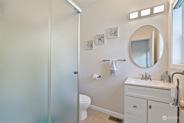 bathroom with vanity, tile patterned flooring, toilet, and a shower with door