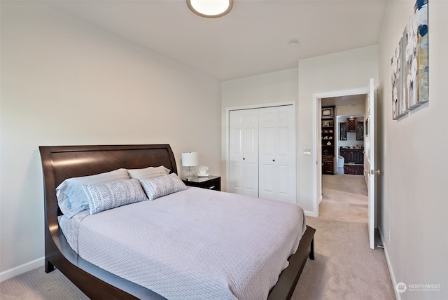 bedroom with light colored carpet and a closet