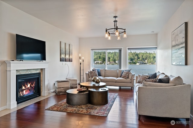 living room with a notable chandelier and dark hardwood / wood-style flooring