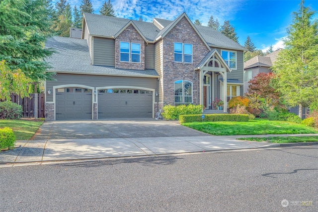 view of front facade featuring a front yard and a garage