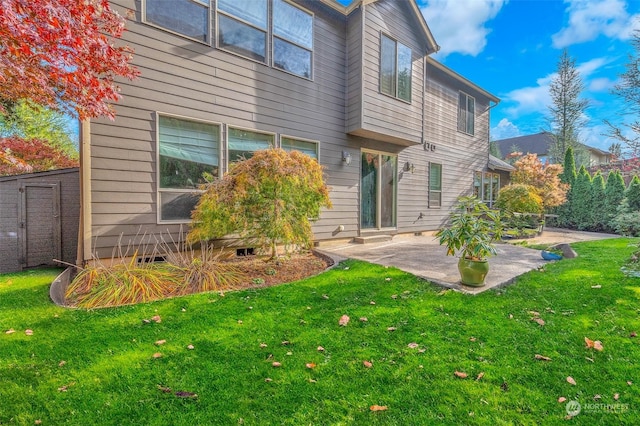 rear view of house featuring a patio area and a lawn