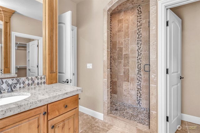 bathroom with vanity, a shower with shower door, and tile patterned flooring