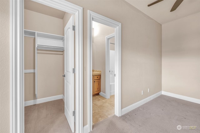 interior space featuring vanity and ceiling fan