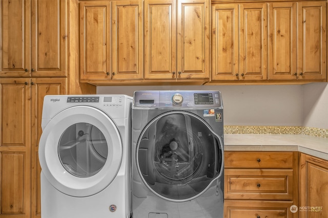 laundry area with cabinets and washer and clothes dryer