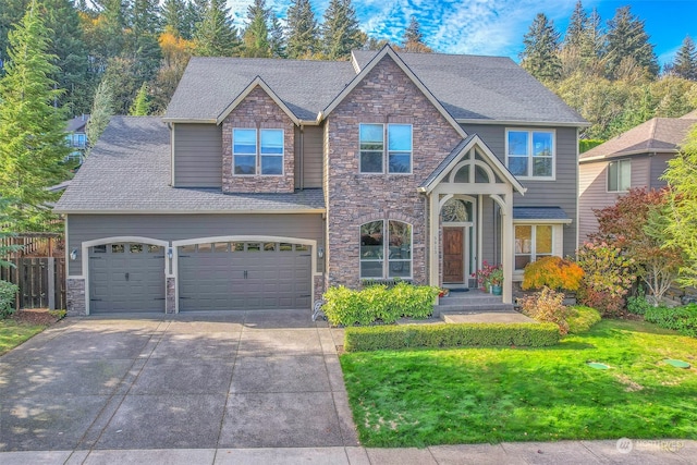 view of front facade featuring a front yard and a garage