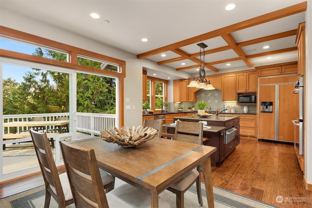 dining room with beamed ceiling, hardwood / wood-style floors, coffered ceiling, and a wealth of natural light