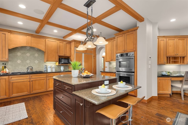 kitchen with black appliances, pendant lighting, dark hardwood / wood-style floors, and a center island