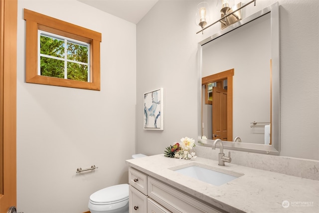 bathroom with vanity and toilet