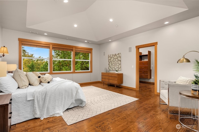 bedroom featuring hardwood / wood-style flooring and lofted ceiling