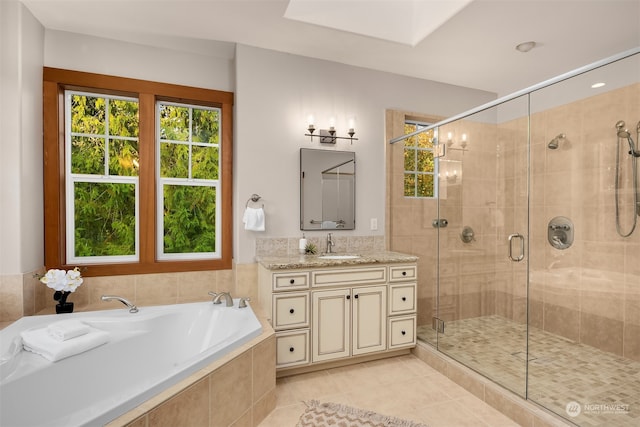 bathroom featuring independent shower and bath, vanity, and tile patterned floors