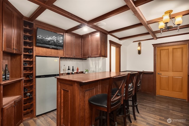 bar featuring stainless steel fridge, beamed ceiling, coffered ceiling, and dark wood-type flooring