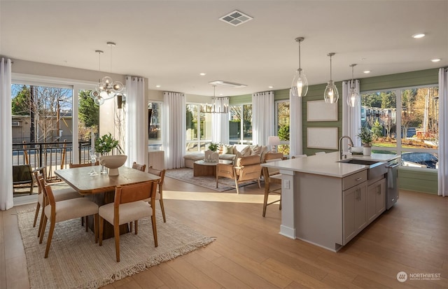 interior space with sink, an inviting chandelier, and light hardwood / wood-style floors