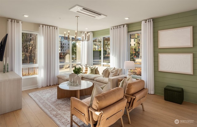 sunroom / solarium featuring a notable chandelier