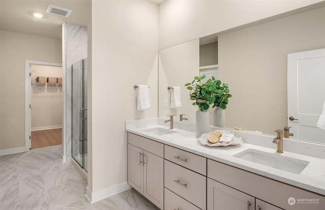 bathroom featuring vanity and a shower with door