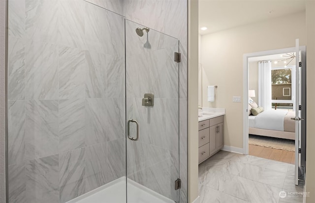 bathroom featuring vanity and a shower with door