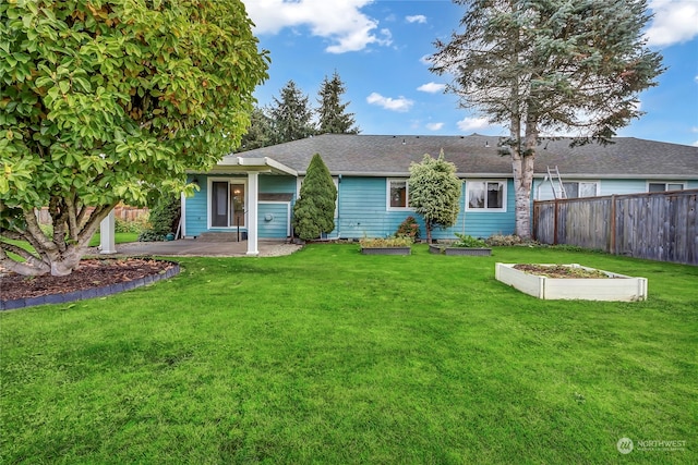 back of house featuring a patio and a yard