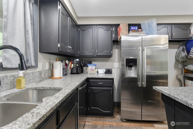 kitchen with dark wood-type flooring, appliances with stainless steel finishes, sink, and light stone counters