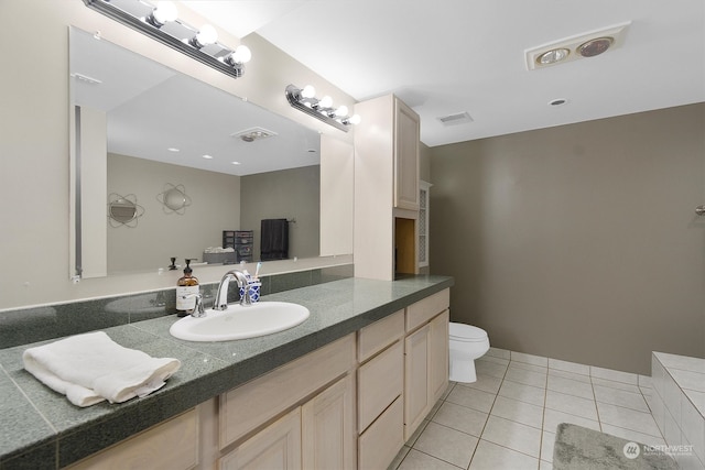 bathroom with tile patterned floors, vanity, and toilet