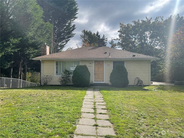 rear view of house with a yard