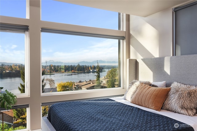 bedroom with a water and mountain view