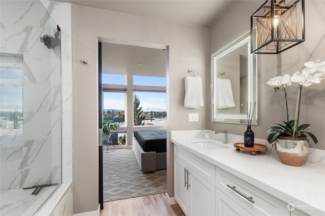 bathroom with a shower, wood-type flooring, and vanity