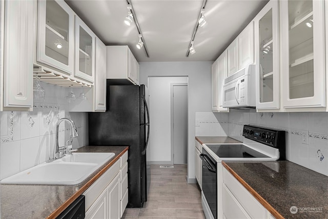 kitchen featuring black appliances, sink, light wood-type flooring, and white cabinetry