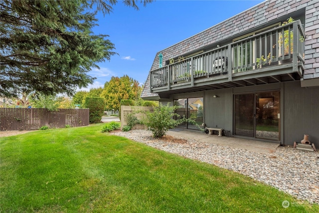 view of yard with a balcony and a patio area