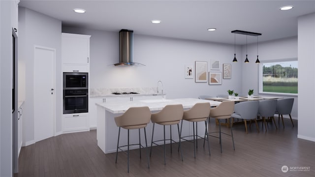 kitchen featuring a center island with sink, wall chimney exhaust hood, dark wood-type flooring, and white cabinetry