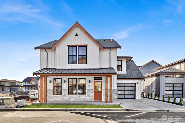 modern inspired farmhouse featuring a garage and covered porch