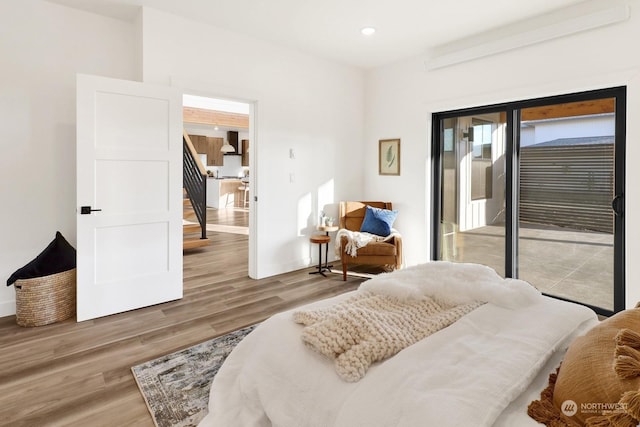 bedroom with hardwood / wood-style flooring and access to outside