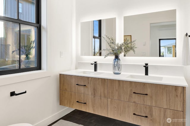 bathroom featuring a healthy amount of sunlight, tile patterned flooring, and vanity