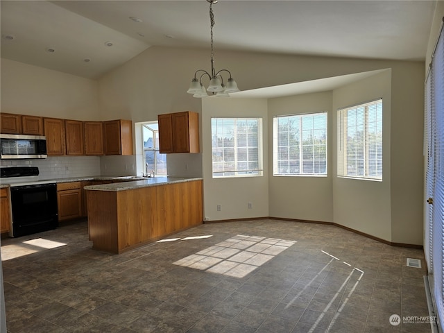 kitchen featuring range with electric stovetop, tasteful backsplash, a wealth of natural light, and decorative light fixtures