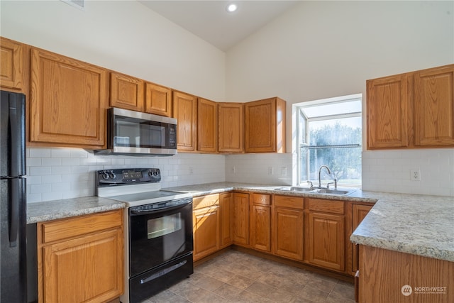 kitchen featuring sink, black refrigerator, backsplash, range with electric cooktop, and high vaulted ceiling