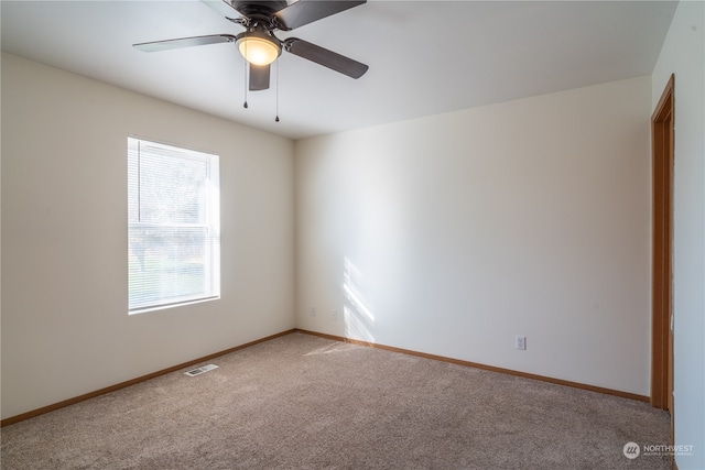 spare room with ceiling fan and carpet flooring