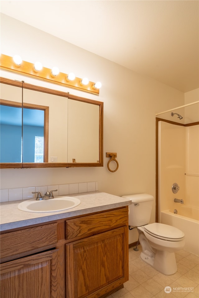 full bathroom featuring tile patterned flooring, vanity, bathtub / shower combination, and toilet