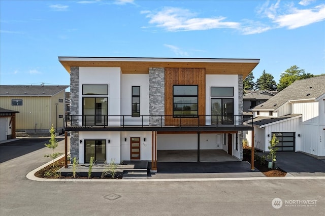 modern home with a balcony and a garage