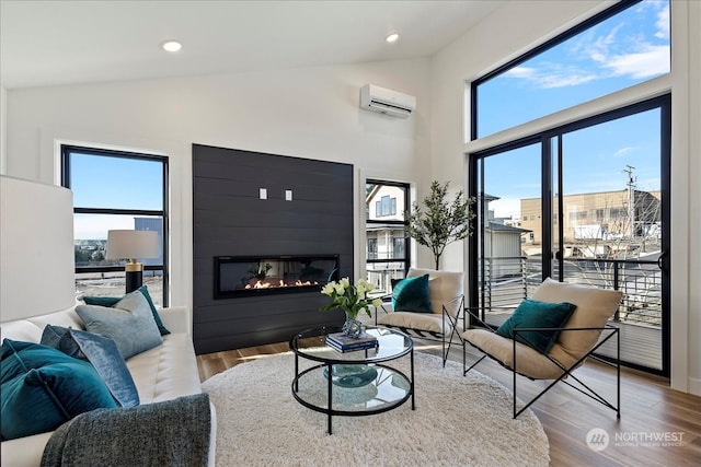 living room with light hardwood / wood-style floors, high vaulted ceiling, and an AC wall unit