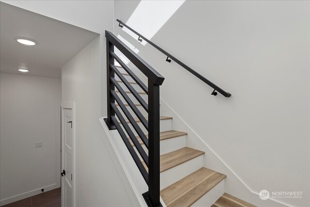 staircase with hardwood / wood-style floors