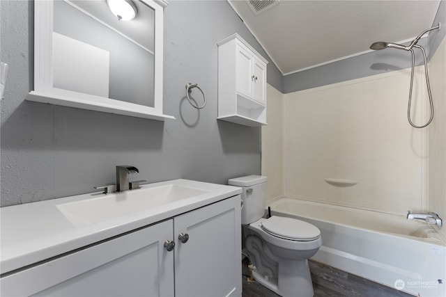 full bathroom featuring wood-type flooring, bathtub / shower combination, vanity, and toilet