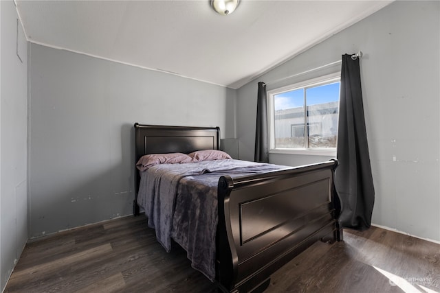 bedroom with dark wood-type flooring and vaulted ceiling