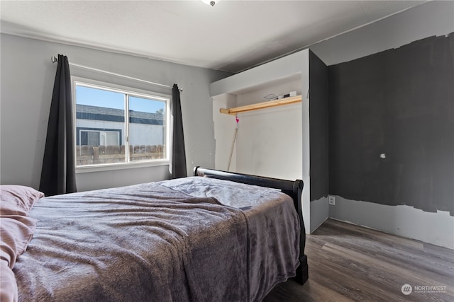 bedroom featuring a closet and dark hardwood / wood-style floors